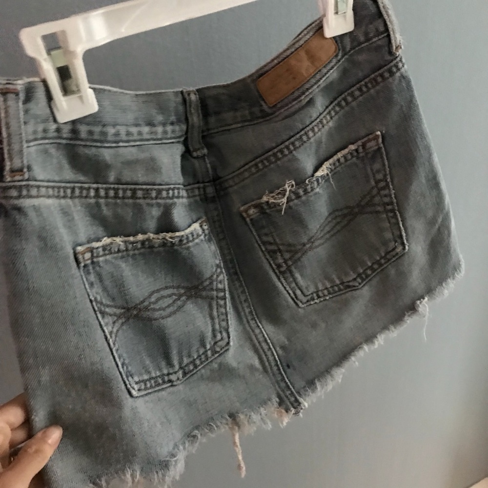 ABERCROMBIE & FITCH distressed denim mini skirt.